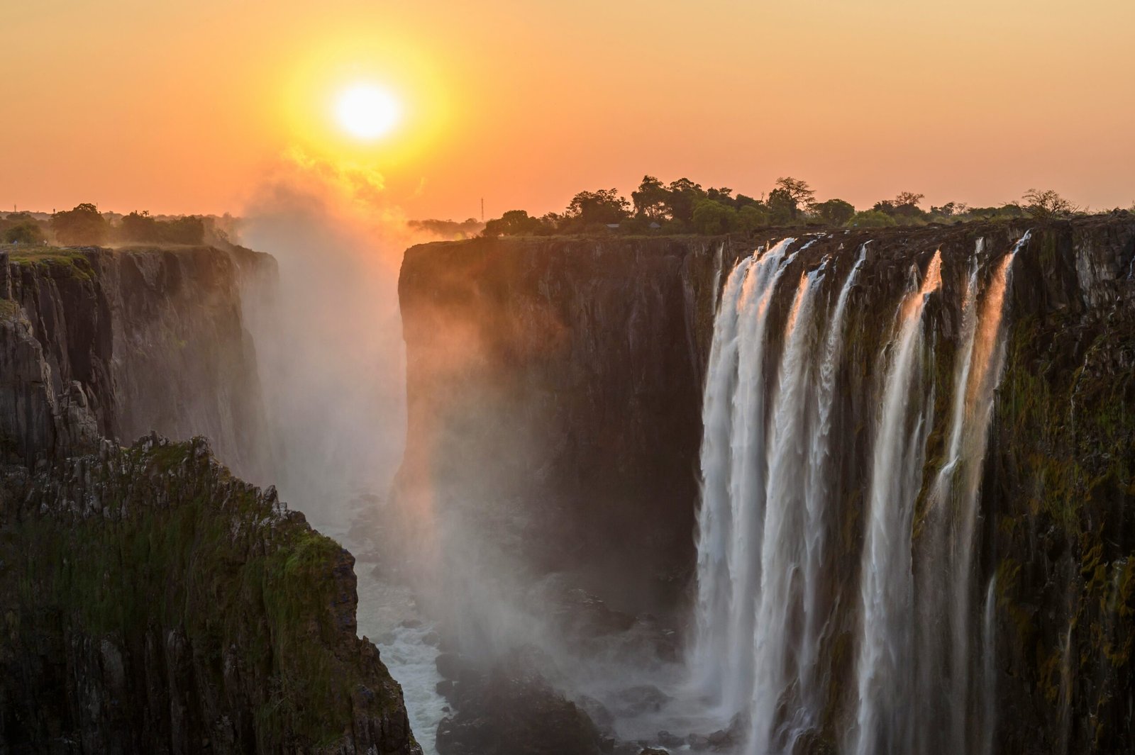 The indigenous name Mosi-oa-Tunya captures the atmosphere of the waterfall exceptionally well. Huge volumes of water striking the gorge below generate mist that rises dramatically above the river, giving the impression of smoke appearing above the landscape.
