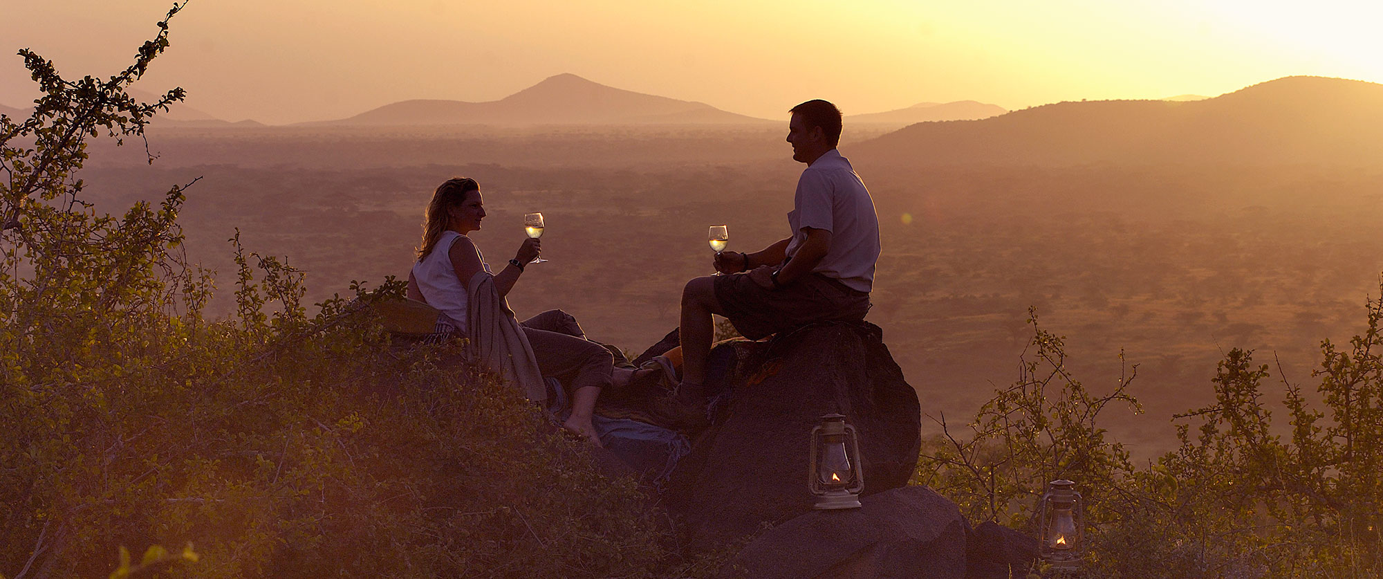 Couple enjoying a sunset drink during safari with Boots in the Jungle Safaris