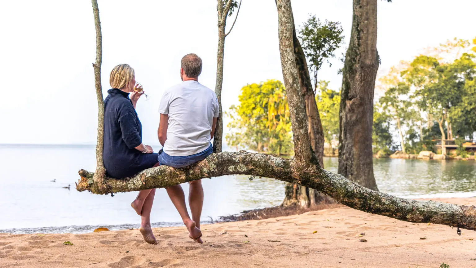 Couple relaxing with a beautiful water view during a luxury African safari holiday with Boots in the Jungle Safaris.