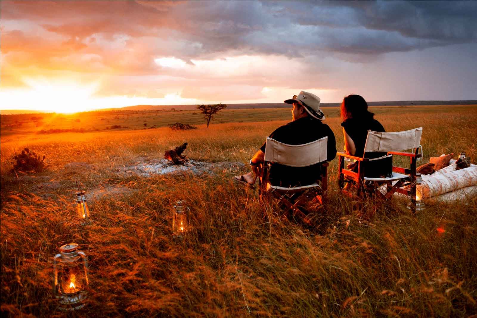 Couple on an evening bush dinner at sunset with Boots in the Jungle Safaris