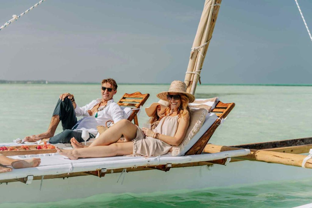 Couple sunbathing during Zanzibar safari and beach honeymoon