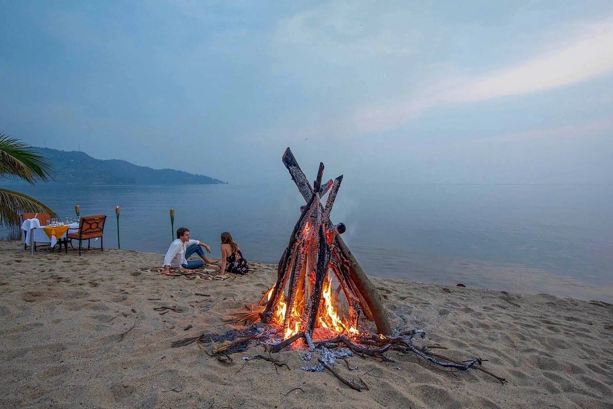 Couple near warming fire at Lake Kivu