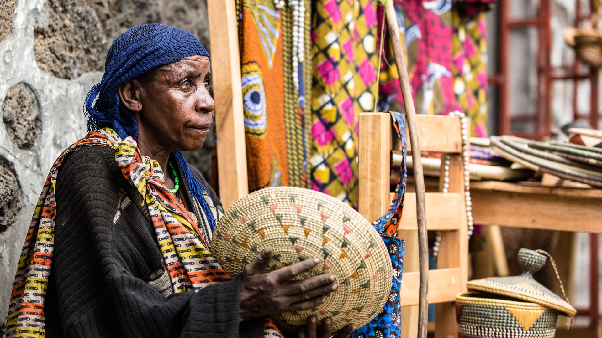 Local artisan making traditional crafts in Kigali Rwanda during a cultural experience with Boots in the Jungle Safaris.