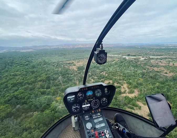 Helicopter flying over a forest during a Rwanda Fly-in Safari